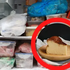 Kawałek pysznego sernika na talerzyku, a obok zamrażarka pełna jedzenia. Czy sernik można mrozic? Tak, by cieszyć się nim później!
