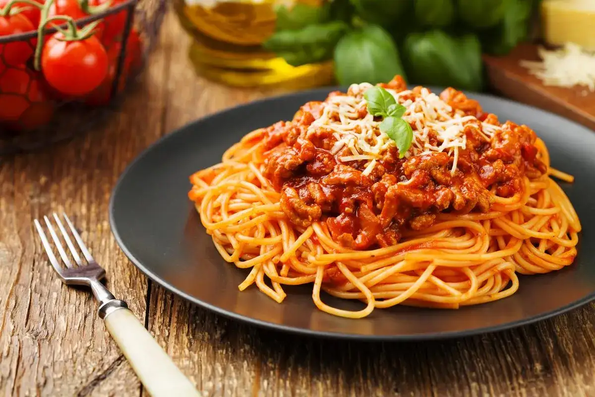 Pyszne spaghetti bolognese na talerzu. Kluczowe jest, jak długo smażyć mięso mielone do spaghetti, by sos był idealny.